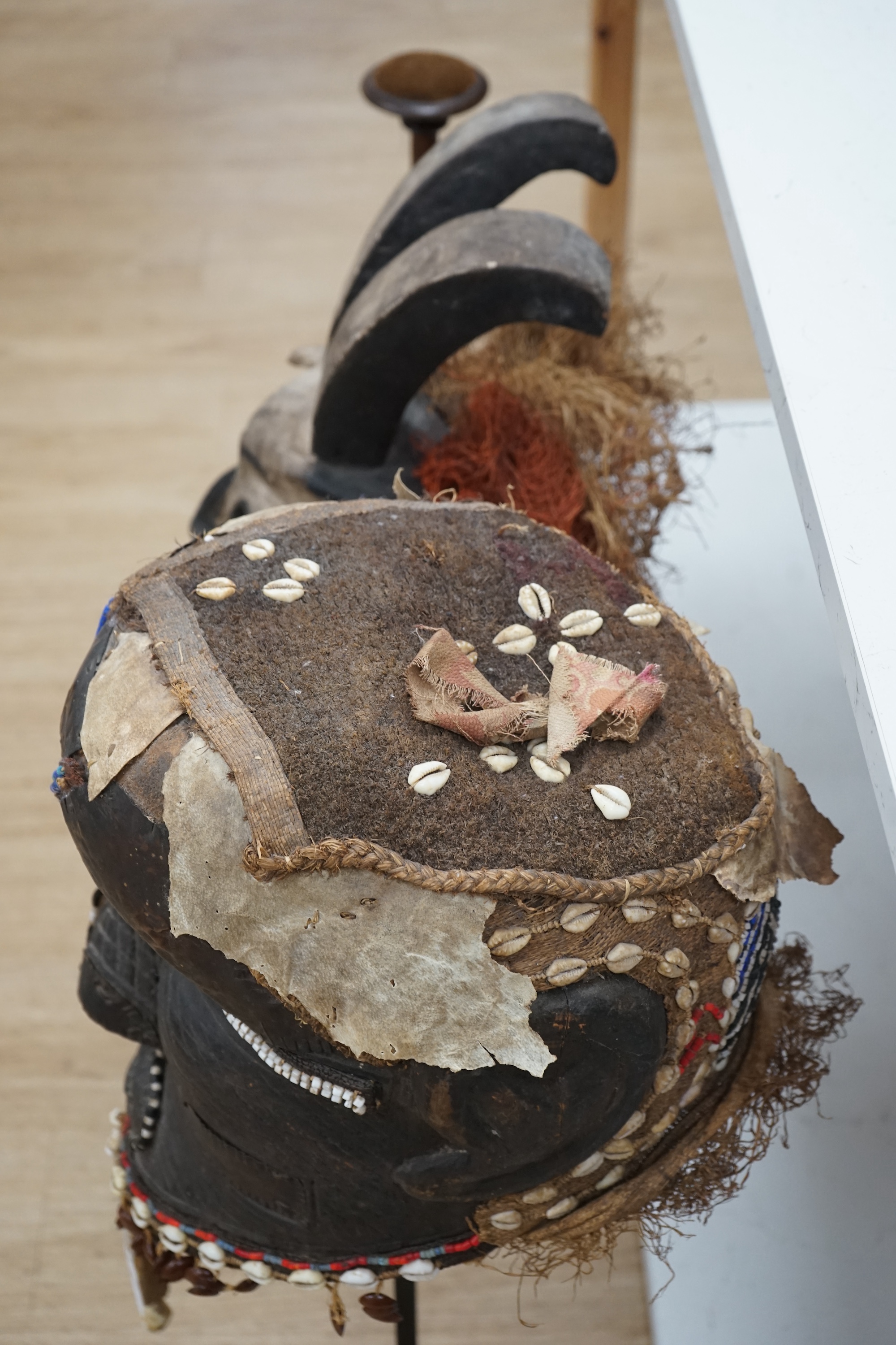 An African Kuba helmet mask and another horned mask, both on stands & one spare. Condition - helmet mask damaged